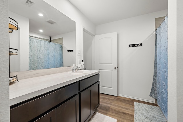 1730 Windstone Ridge Dr, Houston, TX 77014 - full bath with vanity, wood finished floors, recessed lighting, and a shower with shower curtain