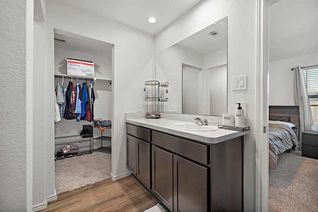 1730 Windstone Ridge Dr, Houston, TX 77014 - full bath featuring connected bathroom, vanity, wood finished floors, and a walk in closet