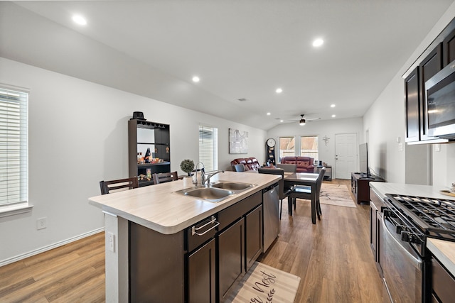 1730 Windstone Ridge Dr, Houston, TX 77014 - kitchen with appliances with stainless steel finishes, light countertops, light wood-style floors, open floor plan, and recessed lighting