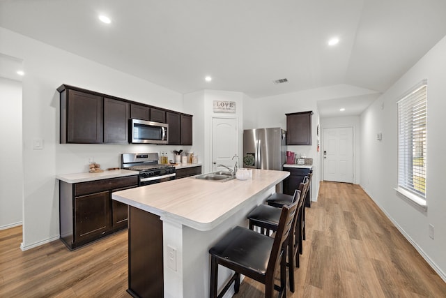 1730 Windstone Ridge Dr, Houston, TX 77014 - kitchen with stainless steel appliances, dark brown cabinetry, light wood finished floors, light countertops, and recessed lighting