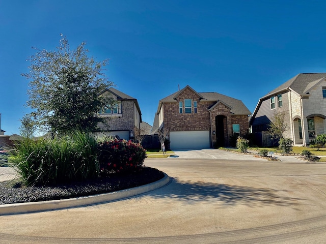 view of front of property featuring driveway, an attached garage, and brick siding