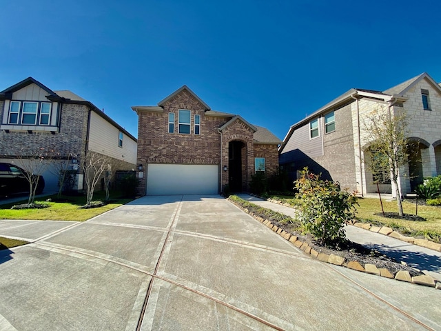 view of front of property with concrete driveway, brick siding, and an attached garage