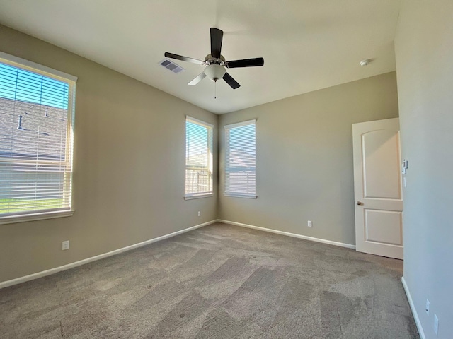 unfurnished room featuring visible vents, ceiling fan, light carpet, and baseboards