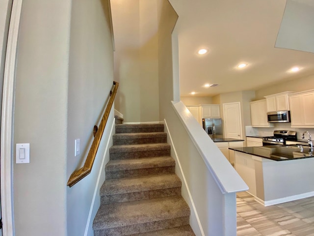 staircase with recessed lighting and baseboards