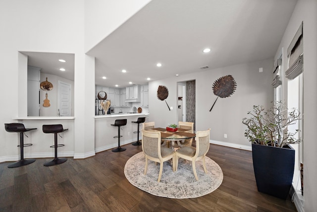 dining space featuring visible vents, baseboards, dark wood finished floors, and recessed lighting