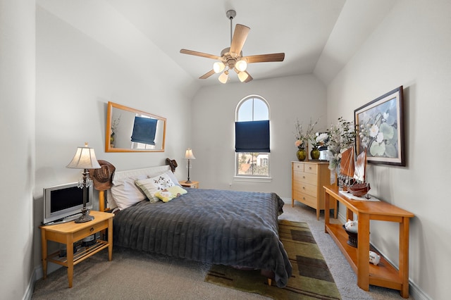 carpeted bedroom featuring baseboards, vaulted ceiling, and a ceiling fan