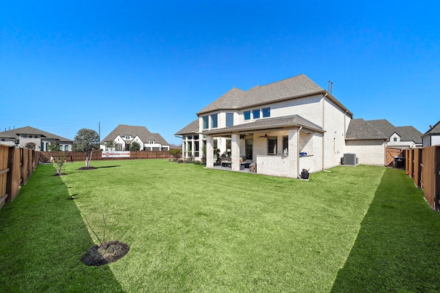 rear view of property with cooling unit, a fenced backyard, a yard, and a patio