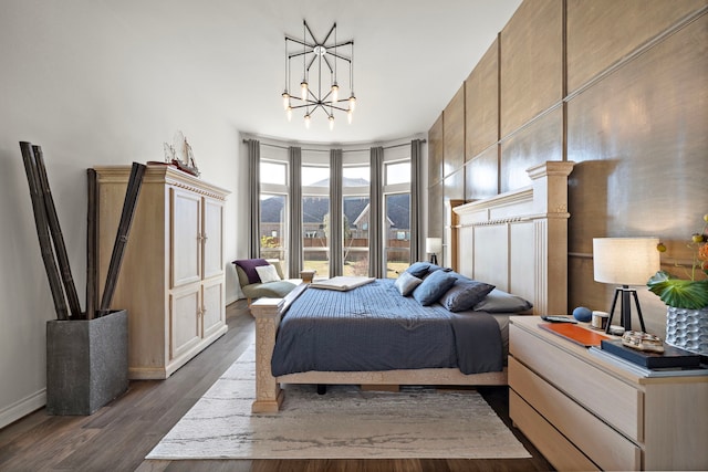 bedroom featuring dark wood-style flooring, a notable chandelier, and a mountain view