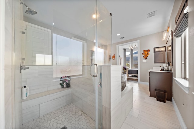 bathroom featuring a stall shower, visible vents, connected bathroom, and vanity