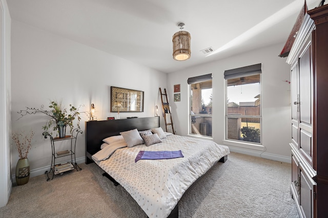 carpeted bedroom with visible vents and baseboards