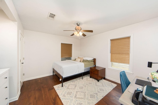 bedroom featuring dark wood-style floors, visible vents, and baseboards