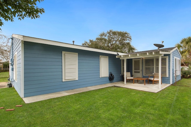 rear view of property featuring a patio area and a yard