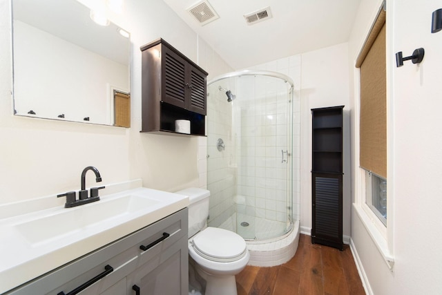 full bath with visible vents, vanity, toilet, and wood finished floors