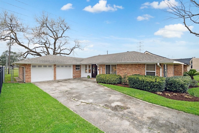 ranch-style home with an attached garage, driveway, a front lawn, and brick siding