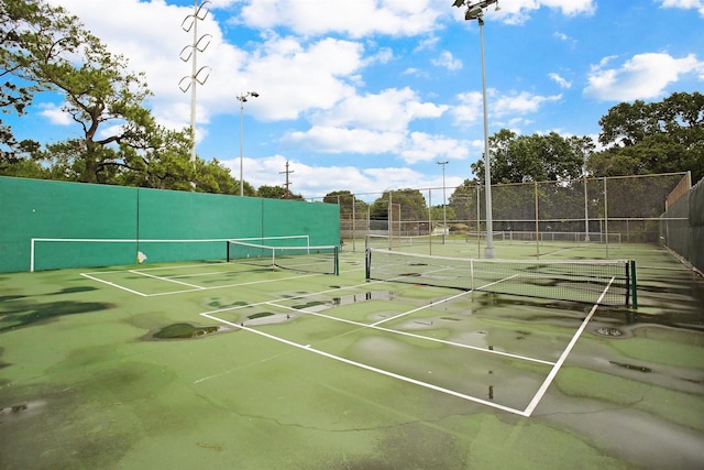 view of tennis court with fence