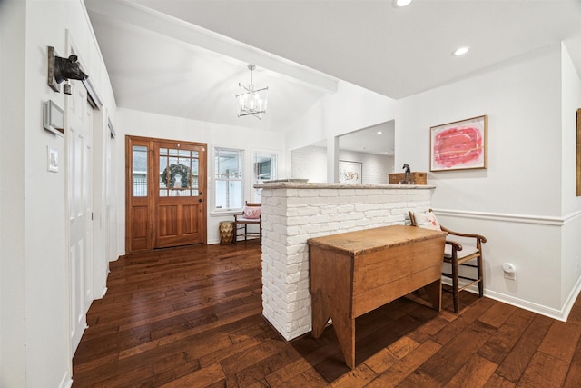 interior space featuring baseboards, dark wood-type flooring, an inviting chandelier, vaulted ceiling, and recessed lighting