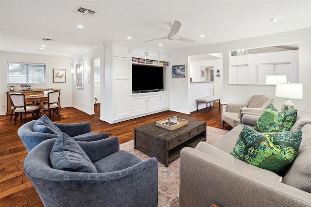 living room with recessed lighting, visible vents, baseboards, and wood finished floors