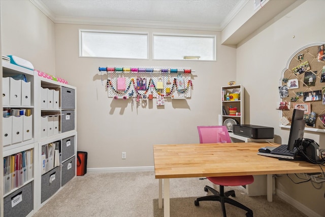 office space with light carpet, a healthy amount of sunlight, baseboards, and crown molding