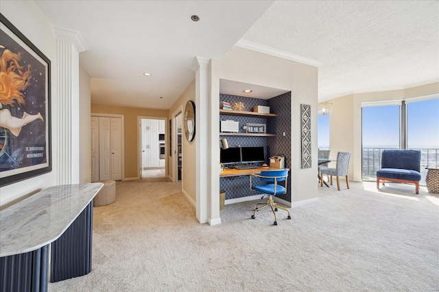 office area with ornamental molding, baseboards, light carpet, and ornate columns