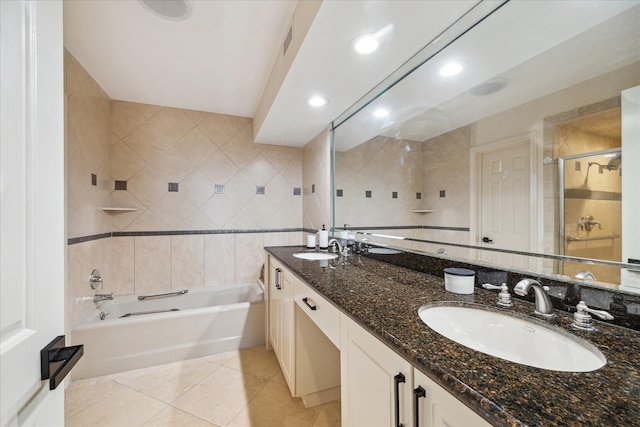 bathroom featuring tile patterned flooring, a sink, and tile walls