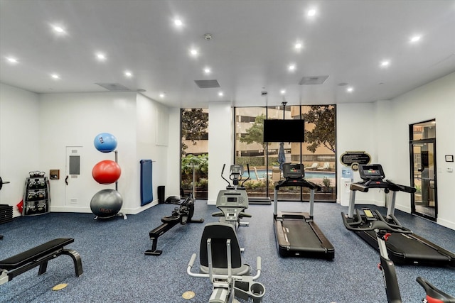 workout area with baseboards, visible vents, and recessed lighting