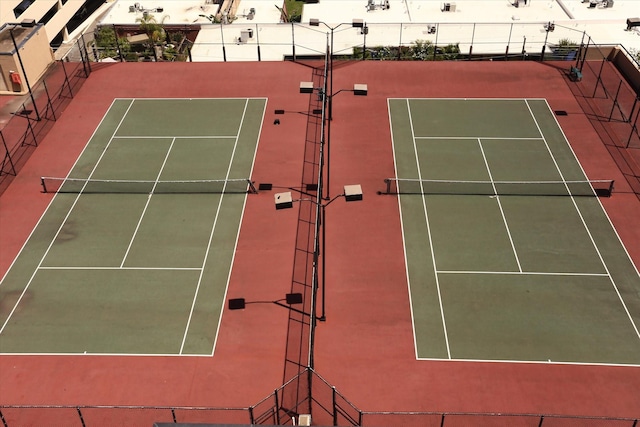 view of tennis court featuring fence