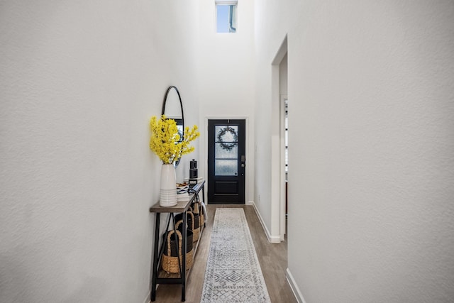 doorway with light wood-style flooring and baseboards