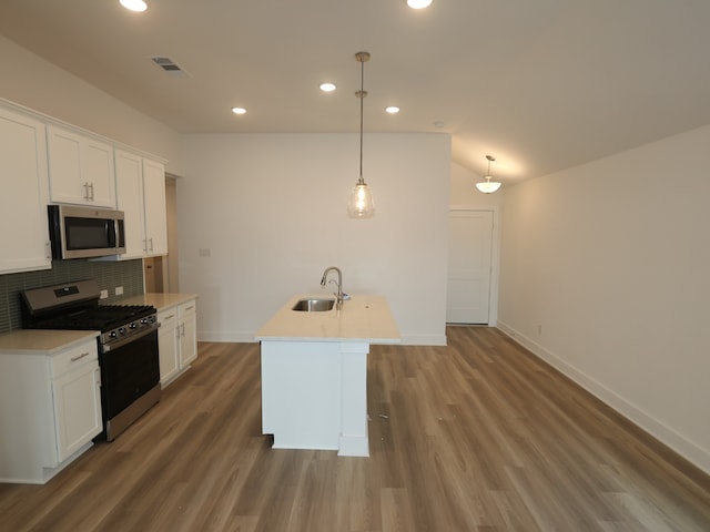 8022 Kay Harbor Dr, Cypress, TX 77433 - kitchen featuring appliances with stainless steel finishes, a sink, tasteful backsplash, recessed lighting, and wood finished floors