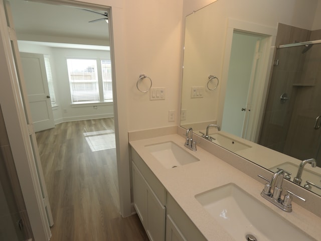 8022 Kay Harbor Dr, Cypress, TX 77433 - bathroom featuring wood finished floors, a shower stall, and double vanity