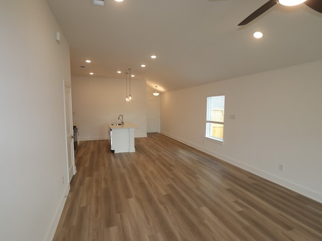 8022 Kay Harbor Dr, Cypress, TX 77433 - unfurnished living room featuring baseboards, wood finished floors, a ceiling fan, recessed lighting, and lofted ceiling