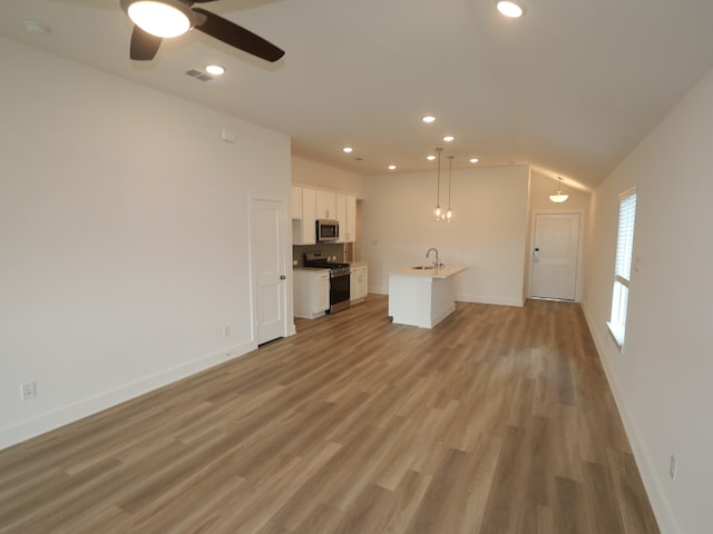8022 Kay Harbor Dr, Cypress, TX 77433 - unfurnished living room featuring a sink, recessed lighting, baseboards, light wood-type flooring, and a ceiling fan