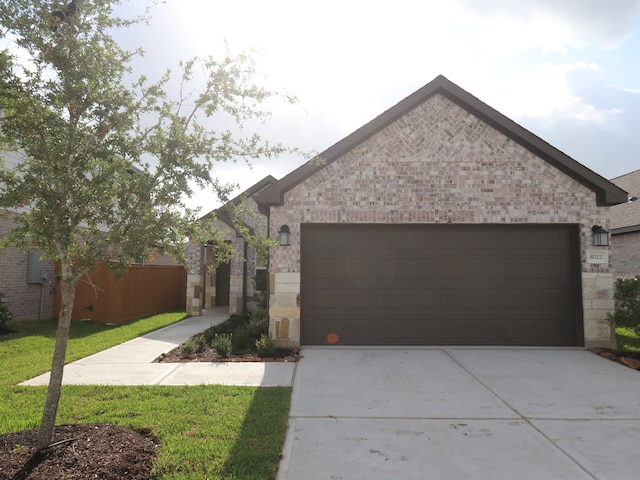 8022 Kay Harbor Dr, Cypress, TX 77433 - view of front of home featuring concrete driveway, brick siding, and an attached garage
