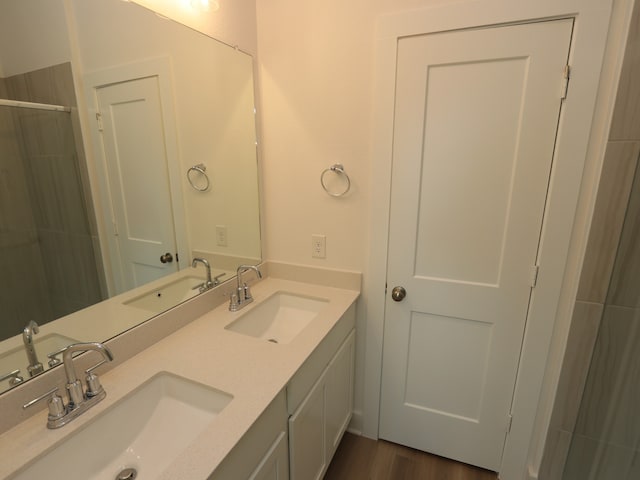 8022 Kay Harbor Dr, Cypress, TX 77433 - bathroom featuring double vanity, a tile shower, and wood finished floors
