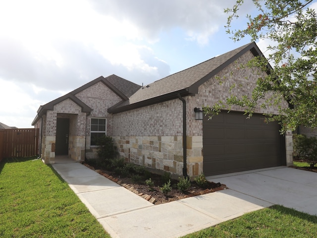 8022 Kay Harbor Dr, Cypress, TX 77433 - french country home featuring an attached garage, stone siding, a shingled roof, and concrete driveway