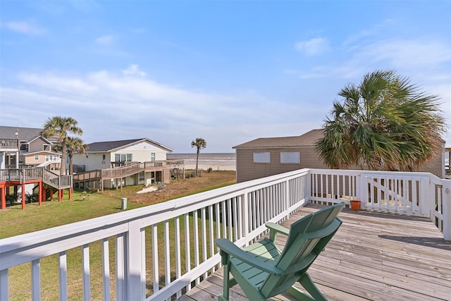 deck featuring a residential view, a water view, and a yard