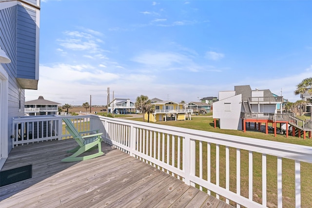 wooden deck with a lawn and a residential view