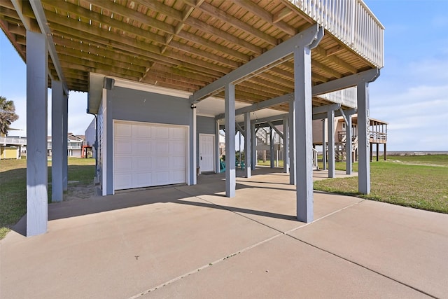 view of patio featuring a garage, a carport, and concrete driveway