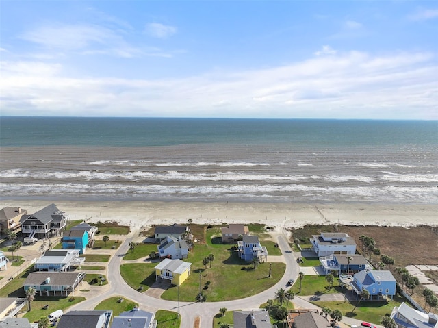 birds eye view of property with a water view, a residential view, and a beach view