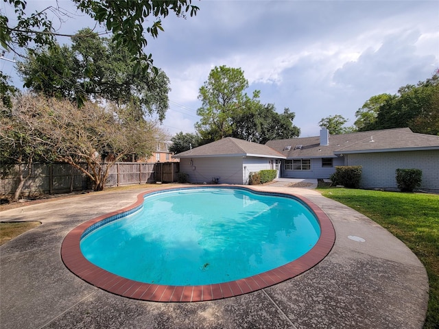 view of swimming pool featuring a fenced in pool, a fenced backyard, and a lawn