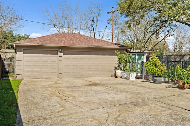 detached garage featuring fence