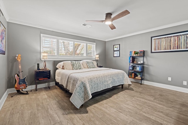 bedroom with crown molding, visible vents, and light wood-style floors