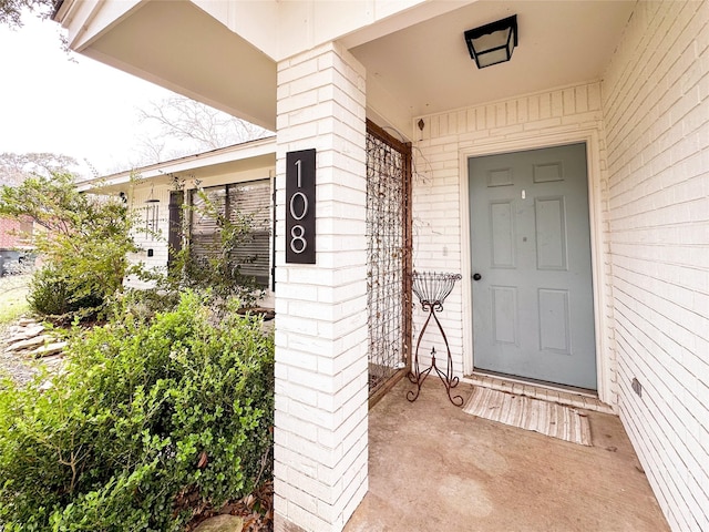 entrance to property with brick siding