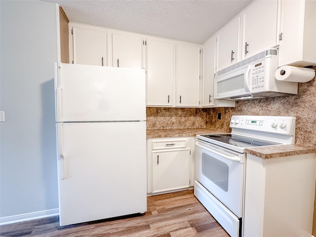 kitchen featuring light wood-style floors, white appliances, light countertops, and white cabinetry