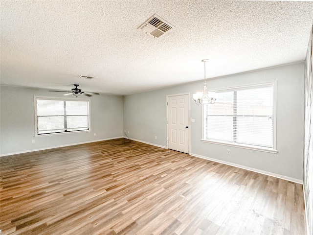 spare room with a wealth of natural light, light wood-style flooring, and visible vents