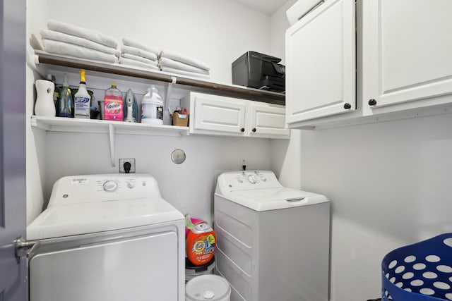 laundry room featuring cabinet space and washer and clothes dryer