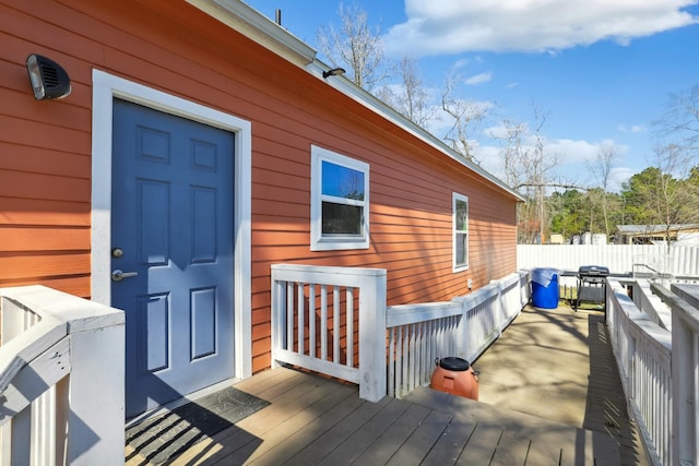 exterior space featuring fence and a deck