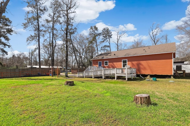 rear view of property with a lawn, fence, a wooden deck, and central air condition unit