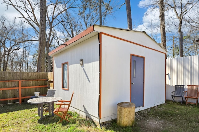 view of outdoor structure with an outbuilding and fence