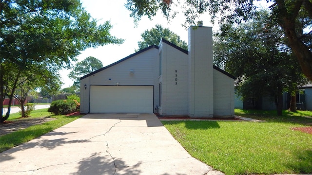 exterior space featuring a garage, driveway, a front lawn, and a chimney