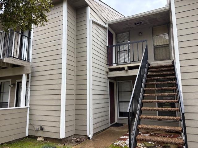 view of side of home featuring stairway